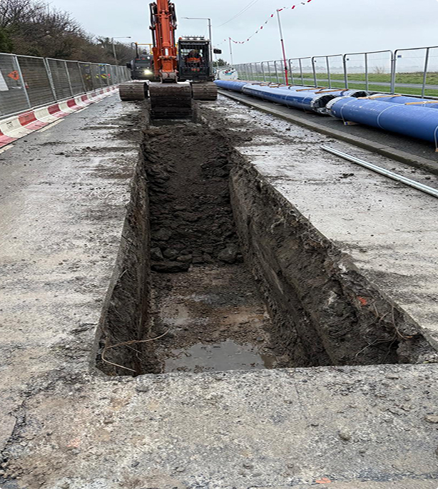ROQ digger digging hole for pipe